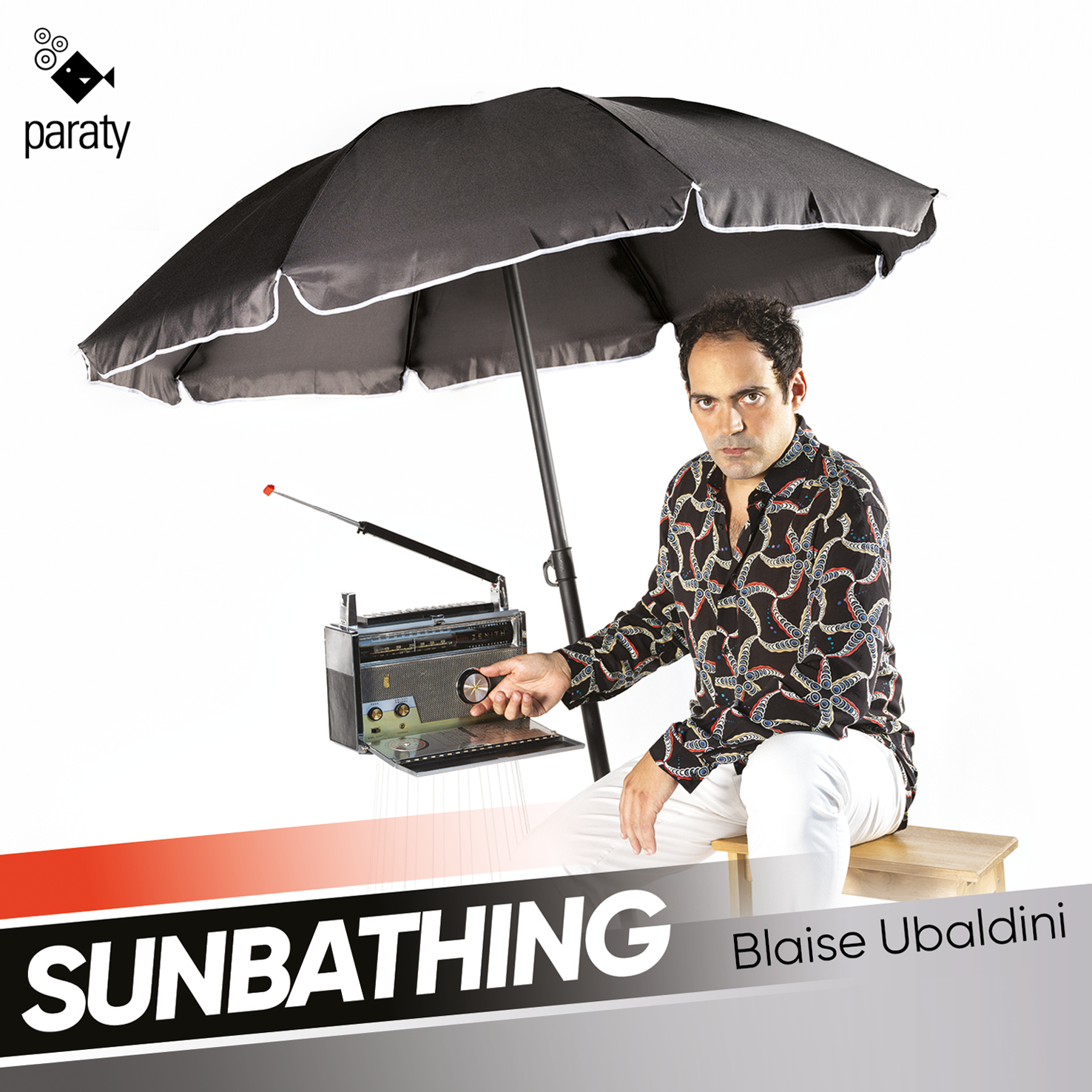 Cover of Blaise Ubaldini's debut album Sunbathing, featuring Blaise seated under a black umbrella with a retro radio.